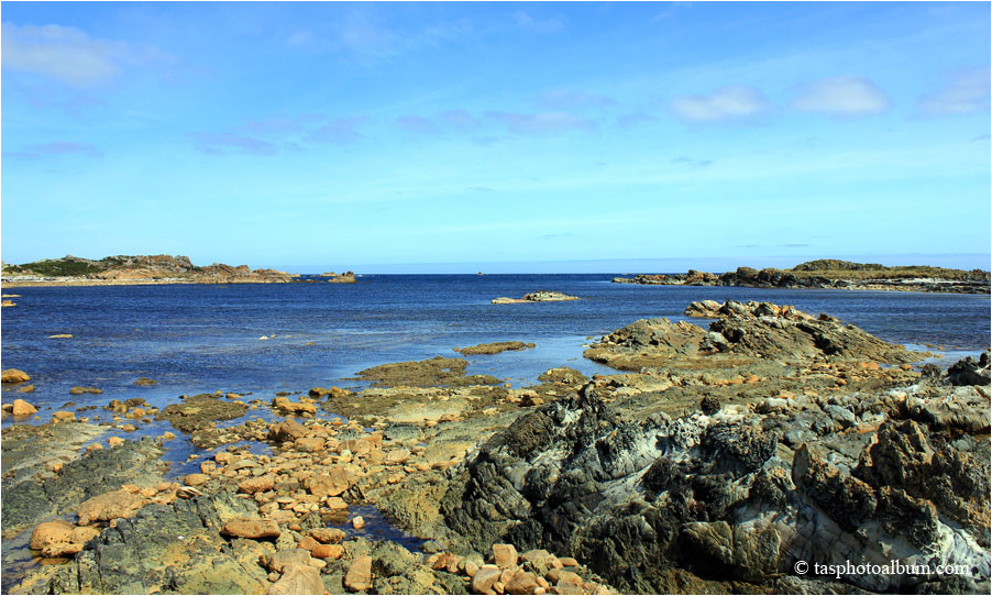 cove at 8/ This is a view from the Edge of the World lookout looking towards the North. It shows the Australia Rock in a swirling sea. The view is symbolic of western Tasmania.